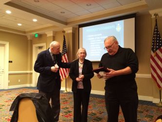 Skip Vichness presents Annabel Horward with a plaque commemorating the announcement of the Annabel Howard Scholarship.